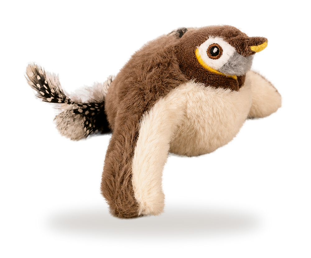 Pájaro cantor de peluche marrón y crema con pico amarillo, con la cola de plumas 