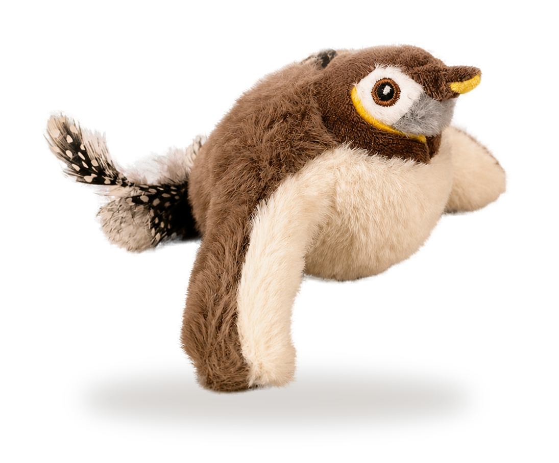 Pájaro cantor de peluche marrón y crema con pico amarillo, con la cola de plumas 